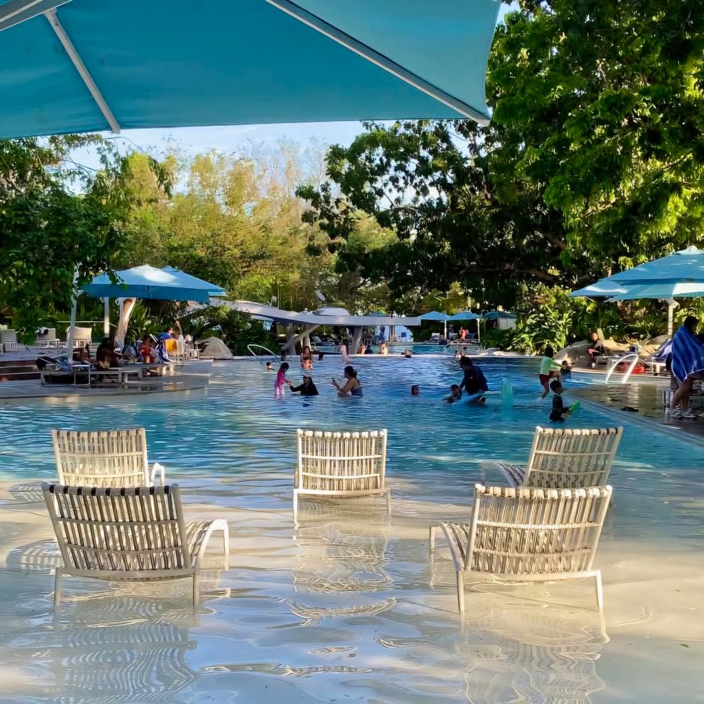 Resort swimming pool with lounge chairs at Tambuli Cebu