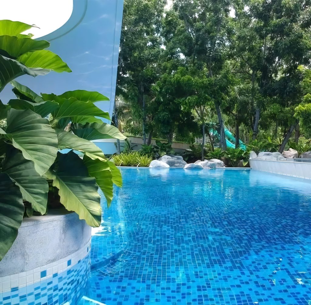 Quiet swimming pool surrounded by greenery at Tambuli