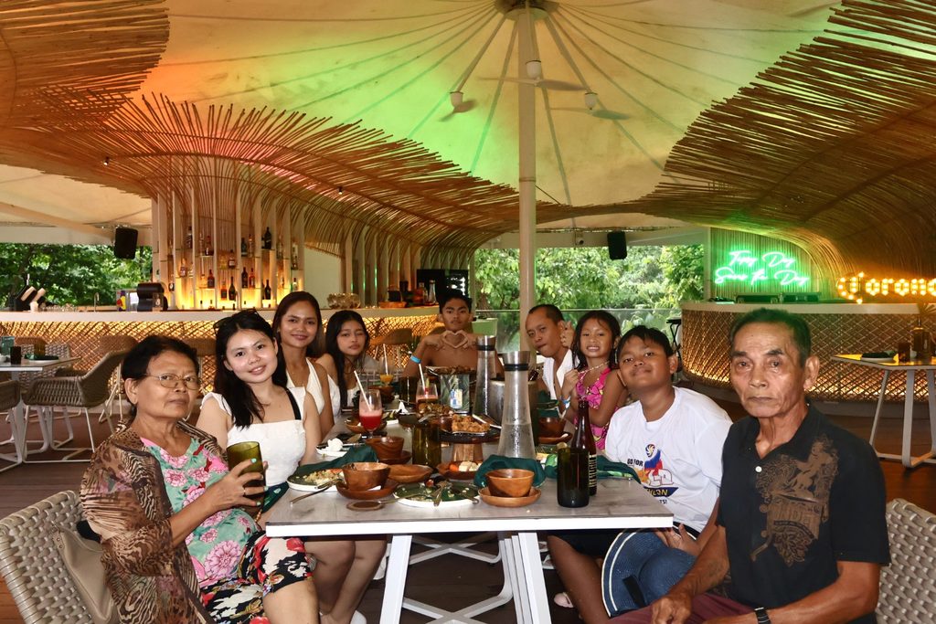 Family enjoying a meal together at Tambuli Seaside Resort Cebu
