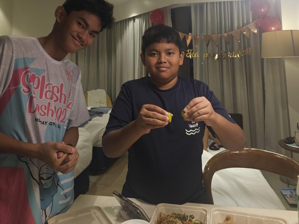 Two boys enjoying food together