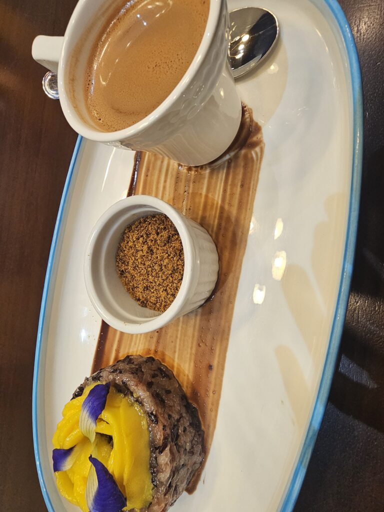 Traditional tablea chocolate and sticky rice with mango at Tambuli Seaside Resort Cebu